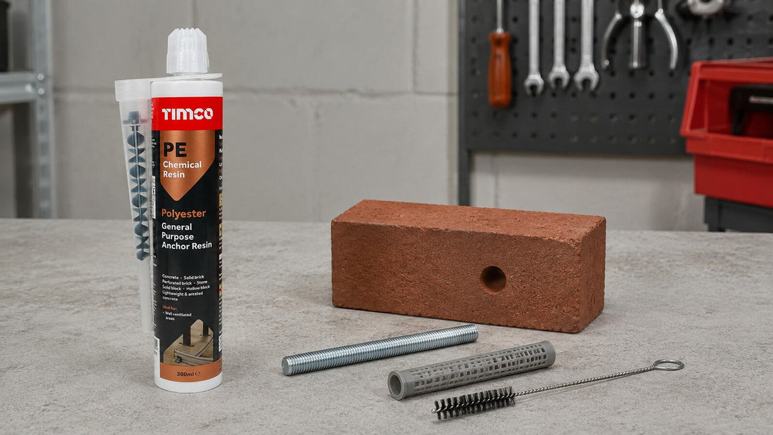 TIMCO PE chemical anchor resin with a drilled brick, threaded rod, resin sleeve and hole-cleaning brush on a workshop bench.