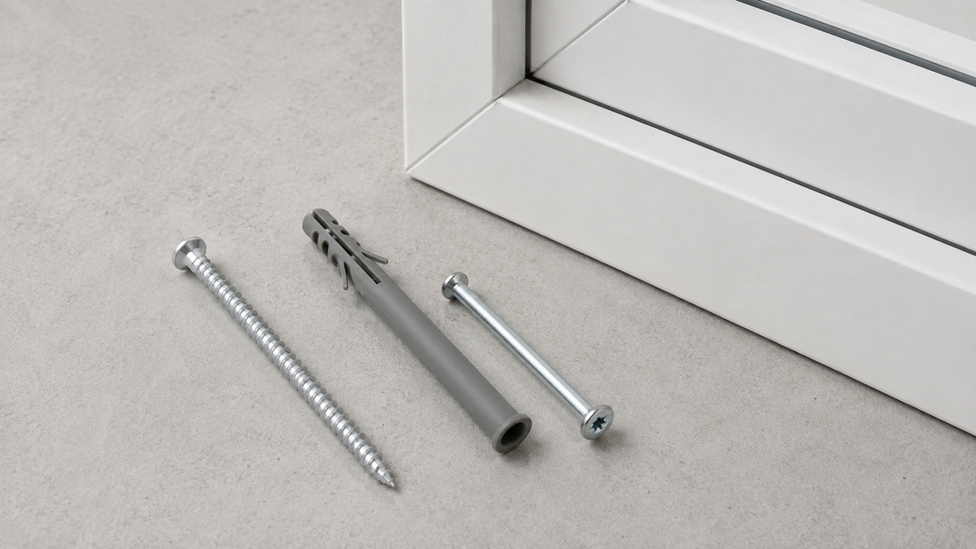 Exterior silver concrete screw and nylon frame fixing beside a white uPVC window frame