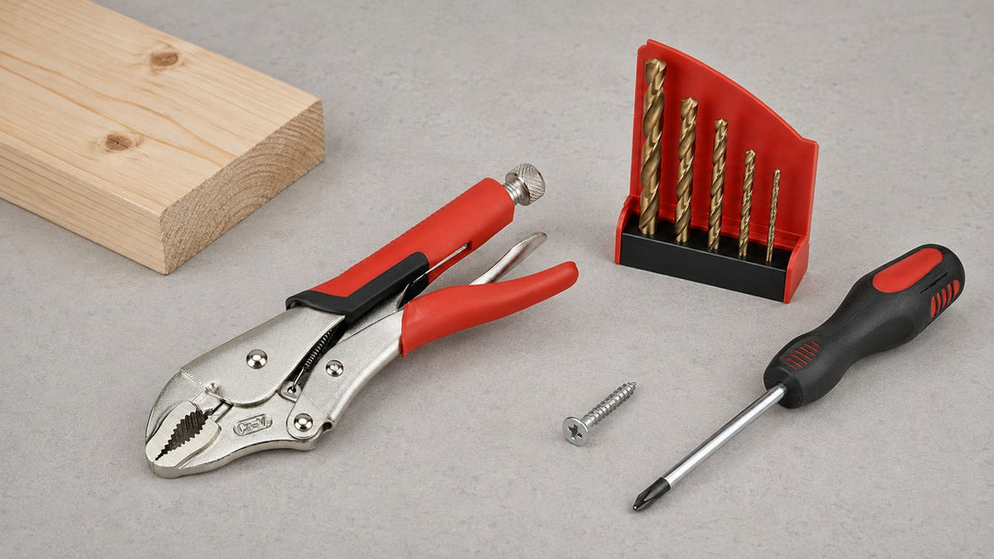 Locking pliers, five cobalt drill bits and a screwdriver beside a damaged screw and pine offcut on a grey workbench.