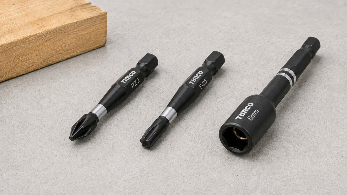 TIMCO PZ2 and TX25 impact bits beside an 8 mm magnetic impact socket driver on a grey workbench.
